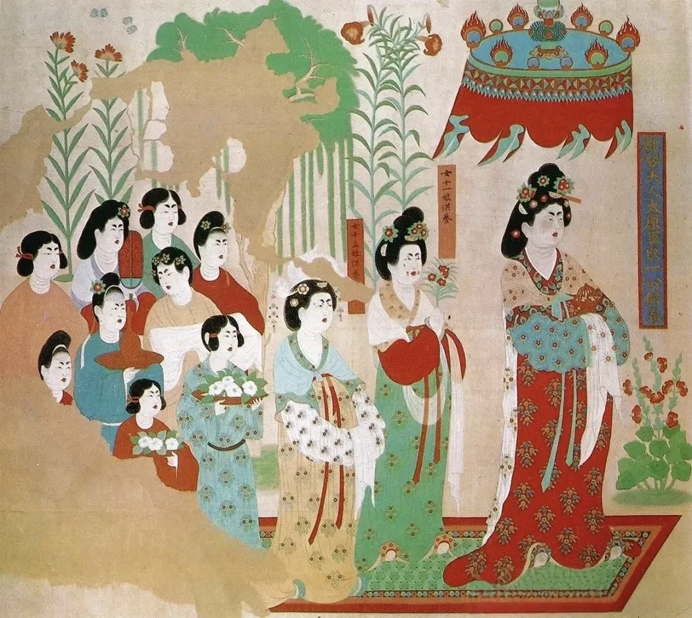 Tang Dynasty Dunhuang cave mural. Noble ladies in traditional Chinese robes. Hollyhock plants are illustrated at the bottom right, proving the flower’s popularity in ancient Chinese art.