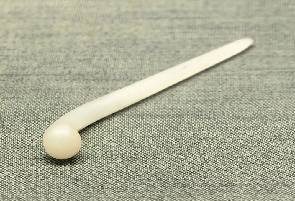 An ancient Chinese white jade hairpin, illustrating the shape that inspired the common name of the jade hairpin flower.